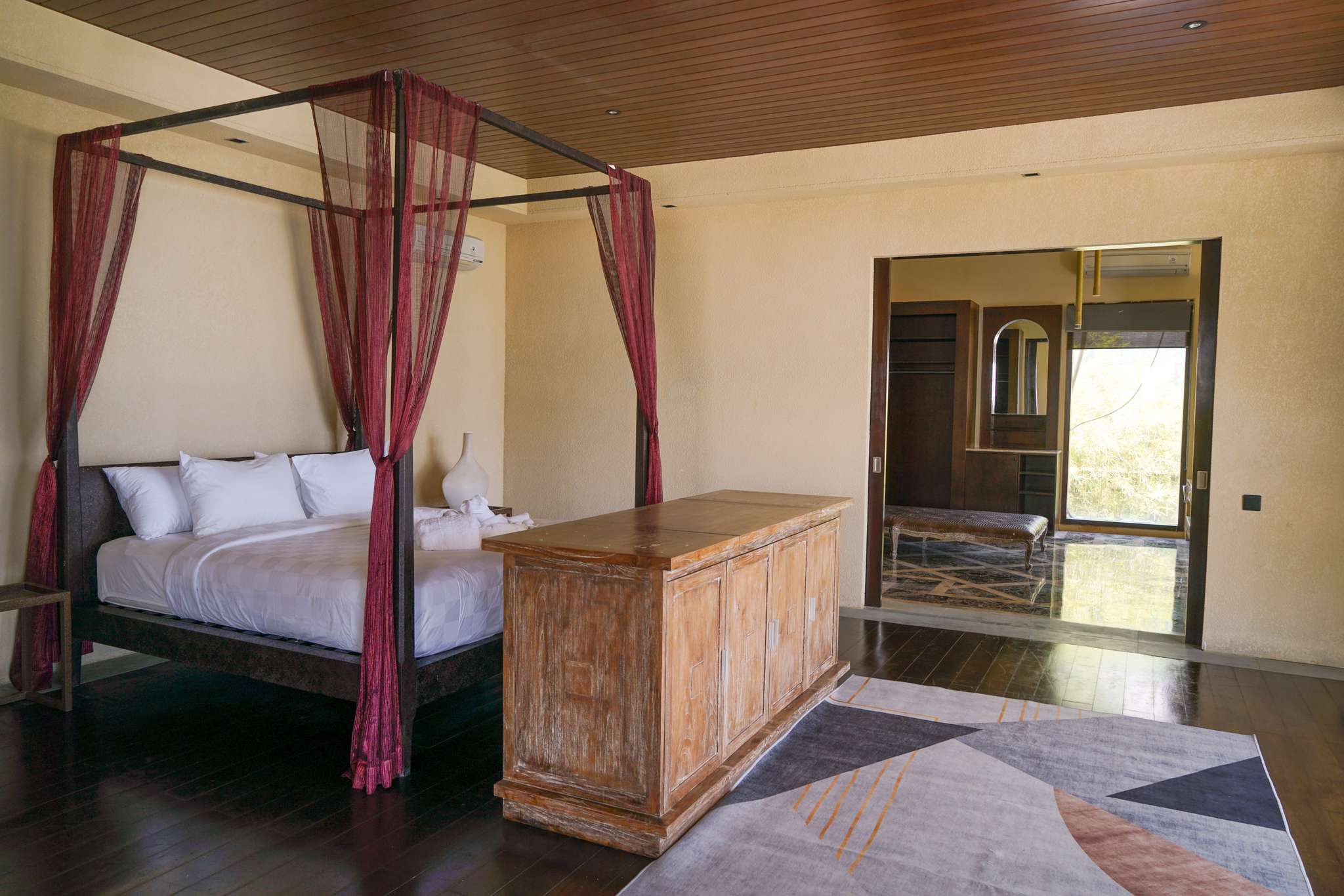 Master suite king bed with panoramic ocean views through floor-to-ceiling windows